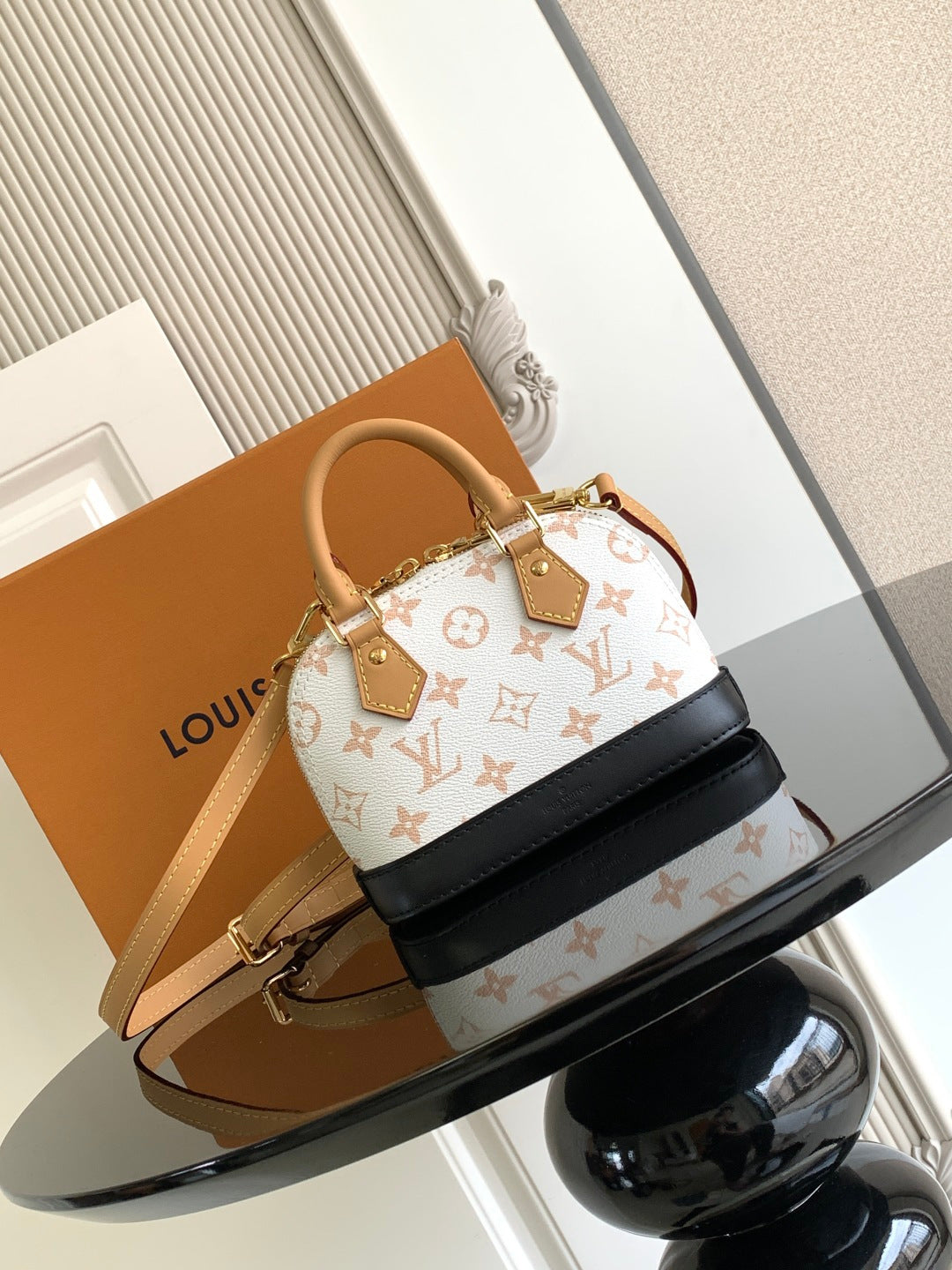 Louis Vuitton mini handbag with white monogram canvas and black leather strap