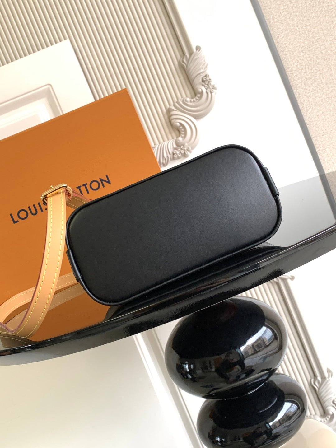 Louis Vuitton crossbody bag with black leather body and curved flap top