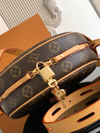 Louis Vuitton monogram bag with gold hardware and tan strap attachment