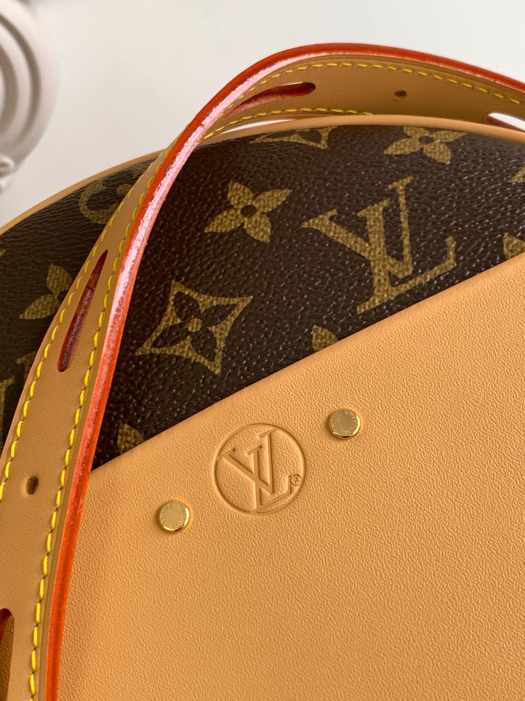 Louis Vuitton bag leather front panel with LV emblem and red trim