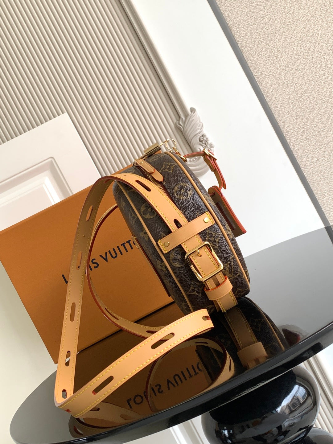 Louis Vuitton monogram crossbody bag with adjustable tan shoulder strap