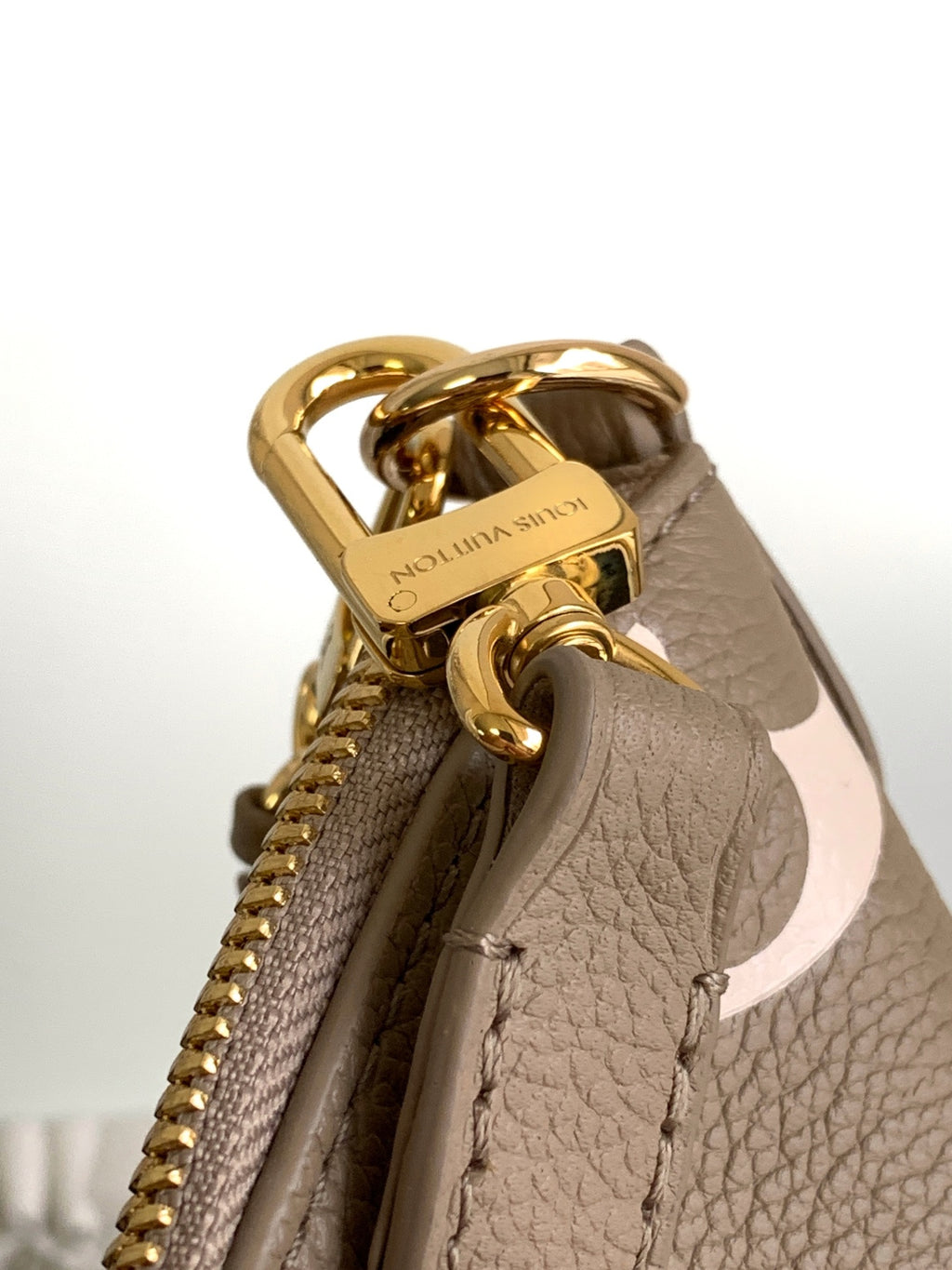 Louis Vuitton monogram bag top hardware with gold handle and zipper opening