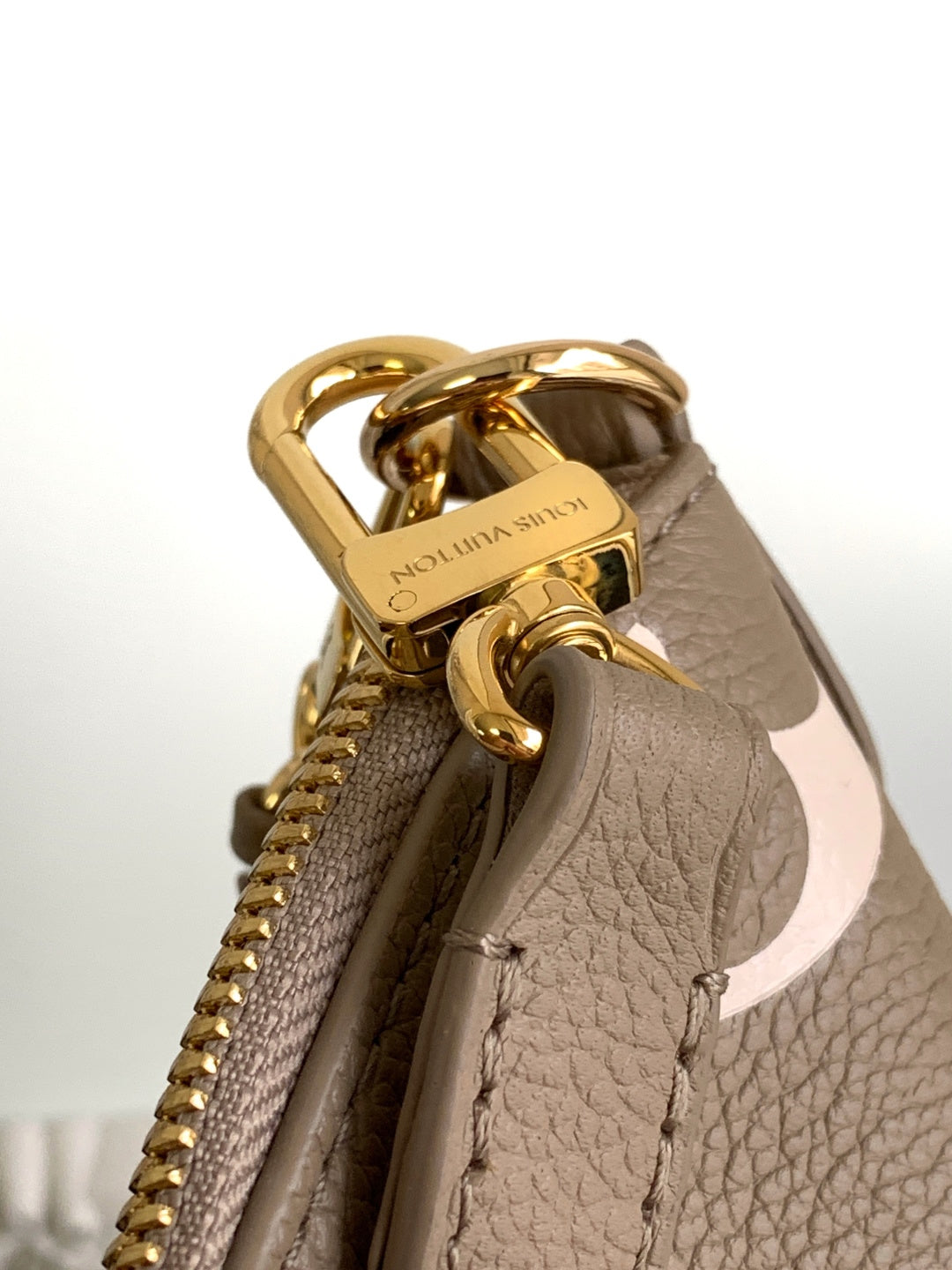 Louis Vuitton monogram bag top hardware with gold handle and zipper opening