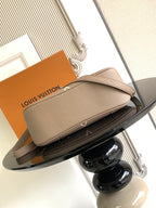 Louis Vuitton monogram clutch-style bag with gold zipper and leather top edge