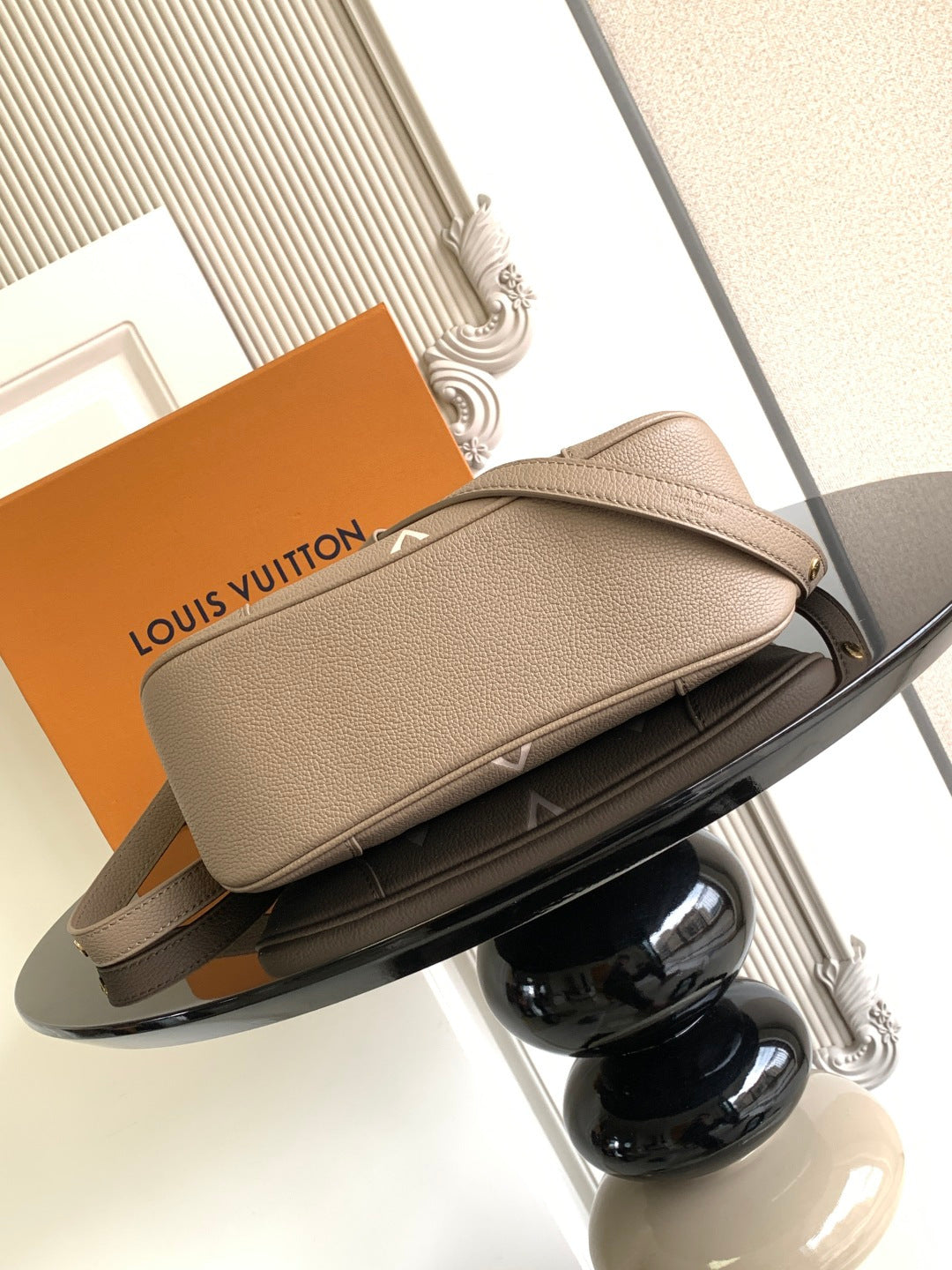 Louis Vuitton monogram clutch-style bag with gold zipper and leather top edge