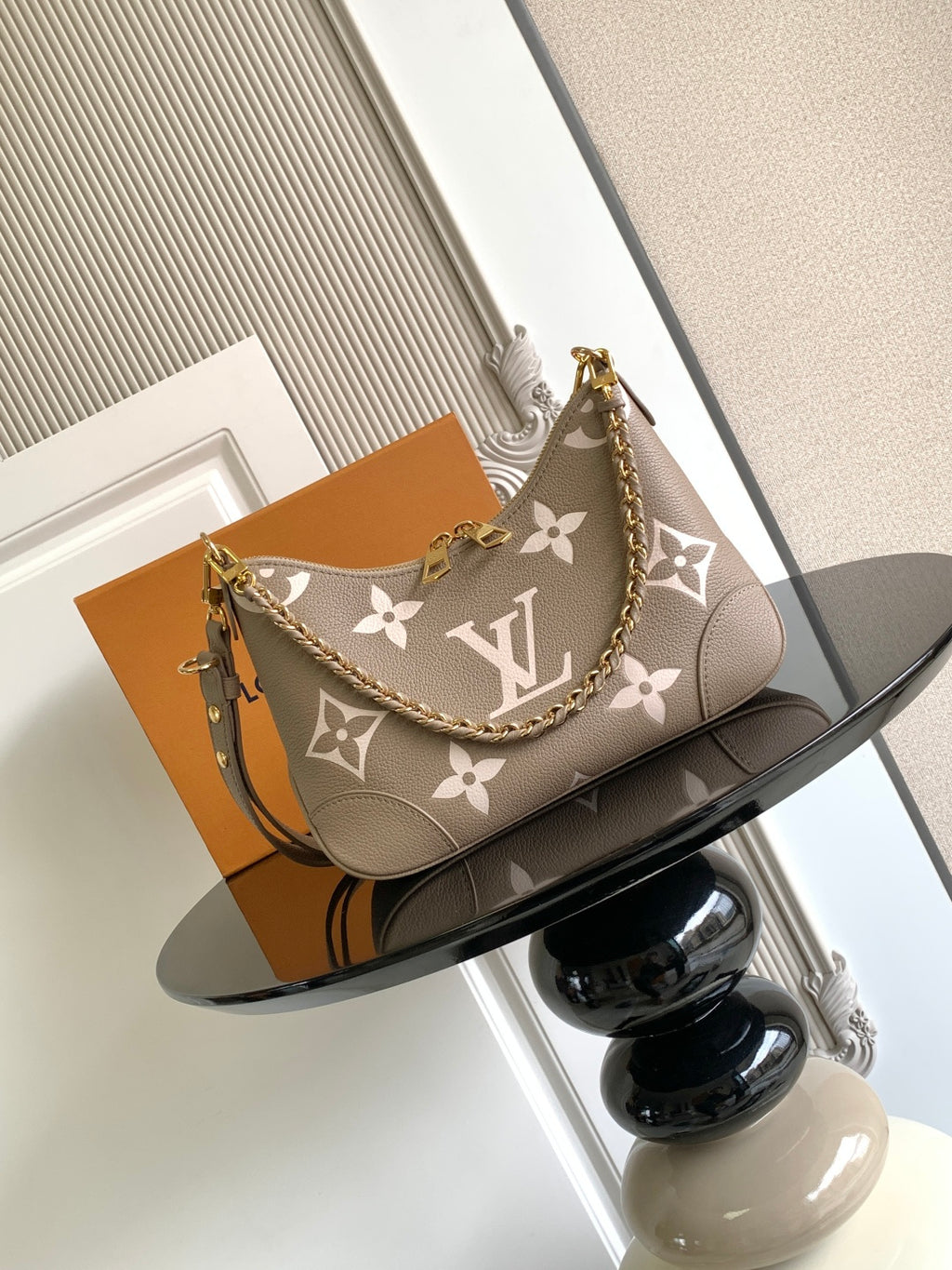 Louis Vuitton monogram shoulder bag with chain strap and floral logo pattern