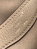 Louis Vuitton monogram bag interior label with embossed logo and stitching