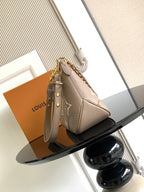 Louis Vuitton monogram handbag with short top handle, gold hardware, and zipper top