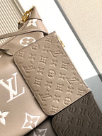 Beige monogram wallet pouch with embossed pattern and gold clasp detail on front.