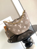 Monogram hobo bag in taupe with white pattern, gold chain strap, and zip top.