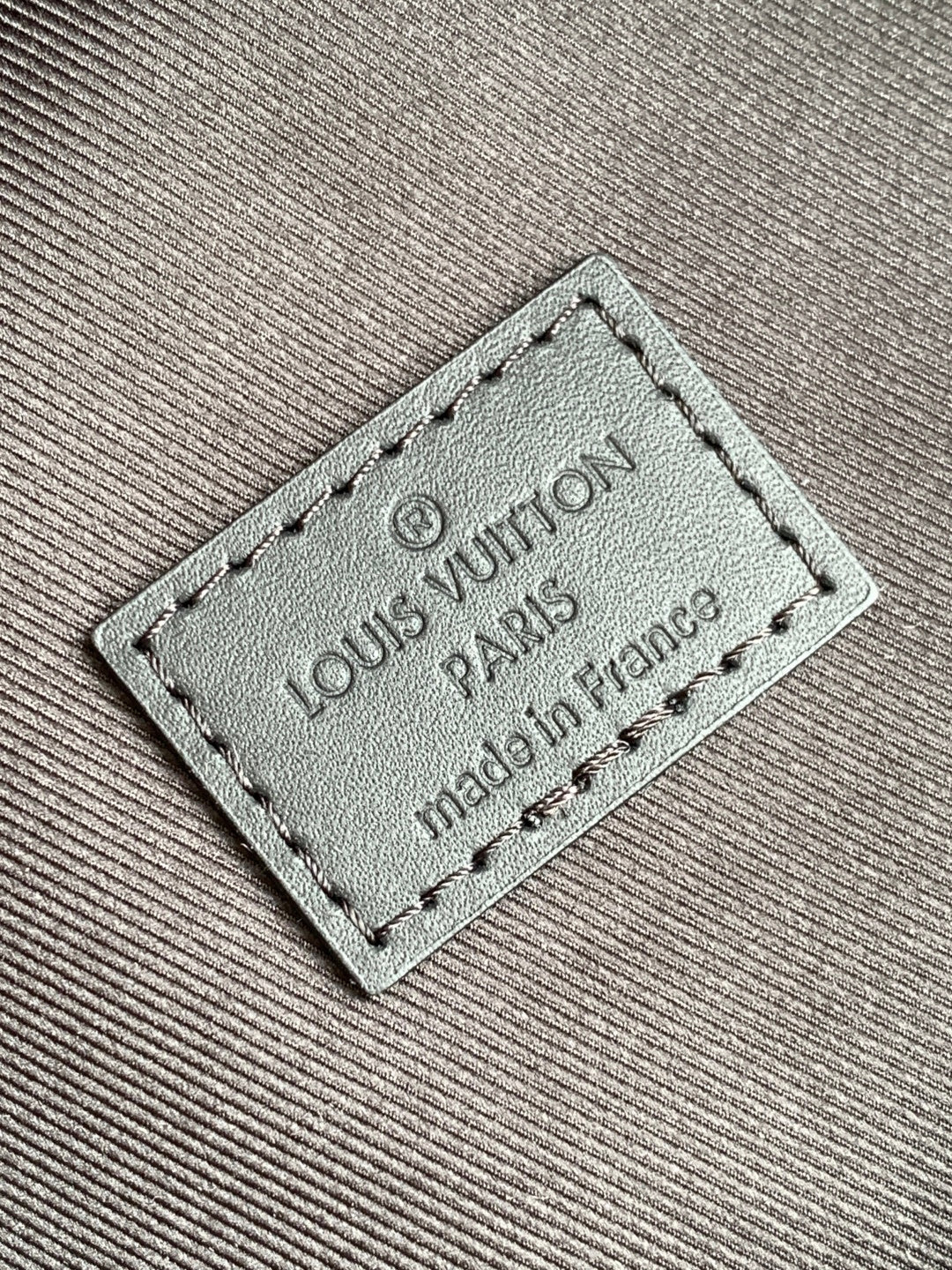 Louis Vuitton Paris leather tag on monogram backpack, made in France