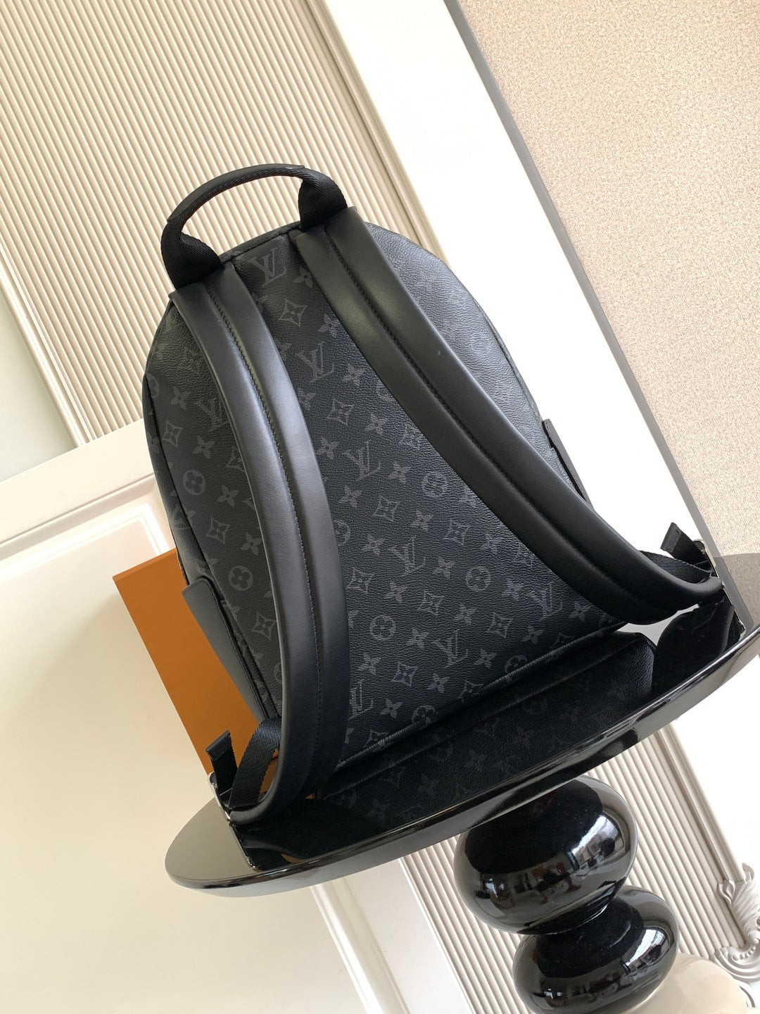 Louis Vuitton monogram backpack angled view, padded shoulder straps and front zip