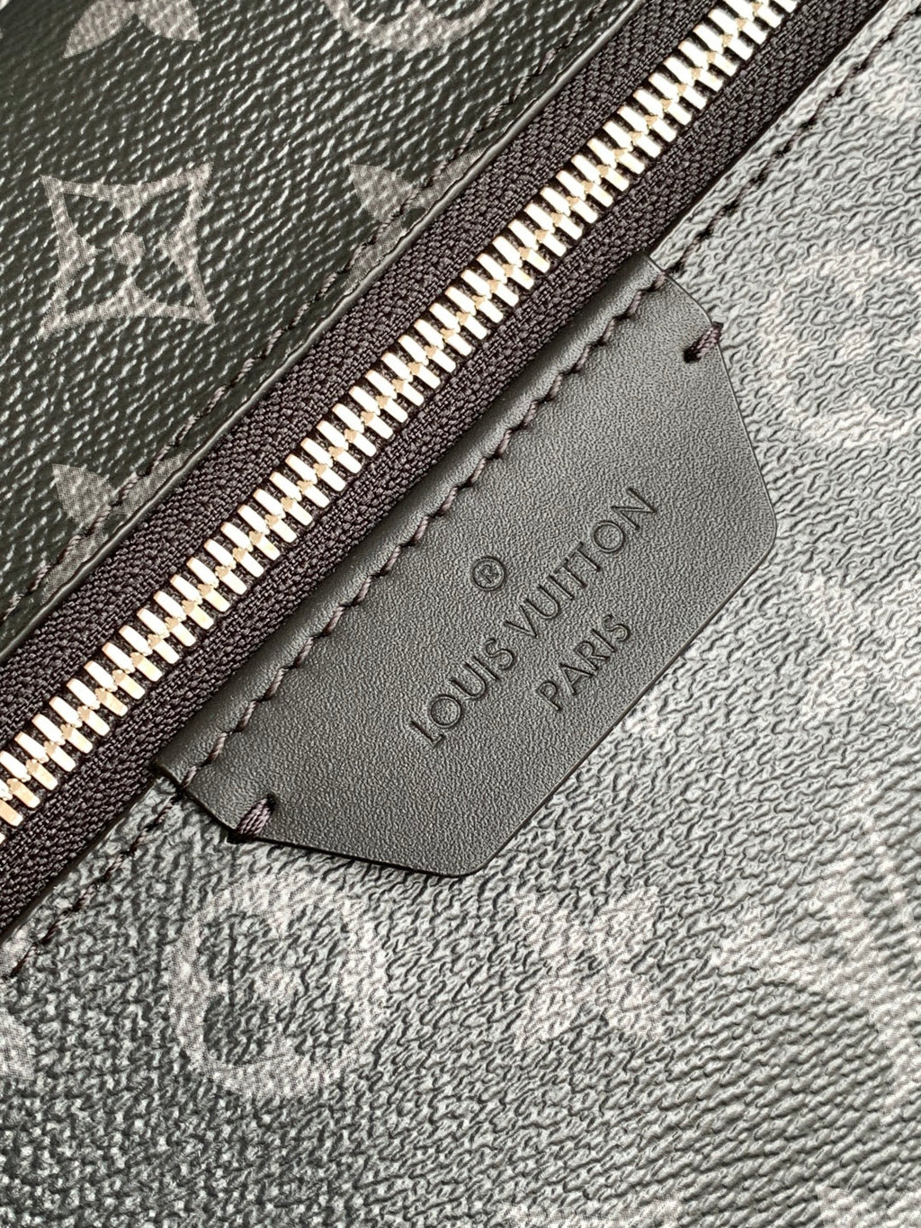 Louis Vuitton Paris leather logo patch on monogram backpack lining