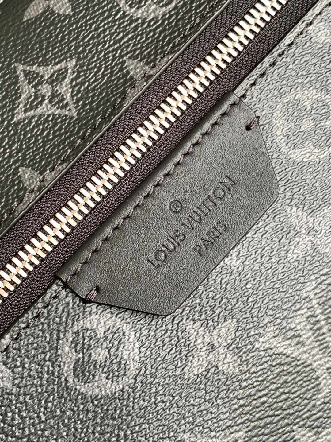 Louis Vuitton Paris leather logo patch on monogram backpack lining