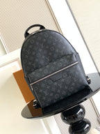 Louis Vuitton monogram backpack with top handle, front zip and adjustable shoulder straps