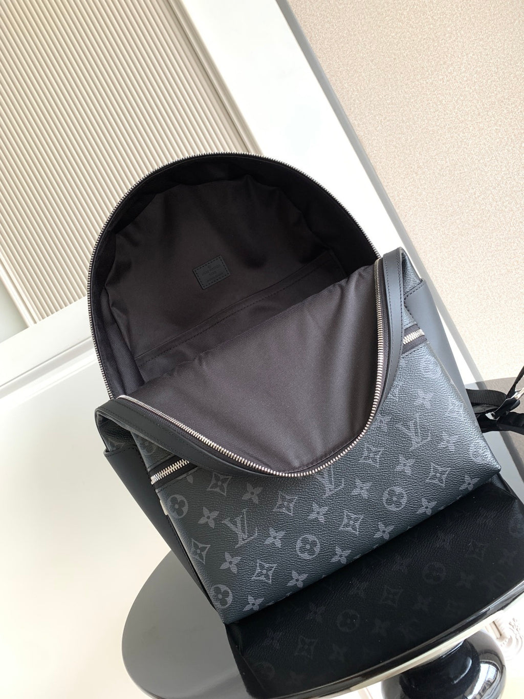 Louis Vuitton monogram backpack open-top view with grey fabric lining