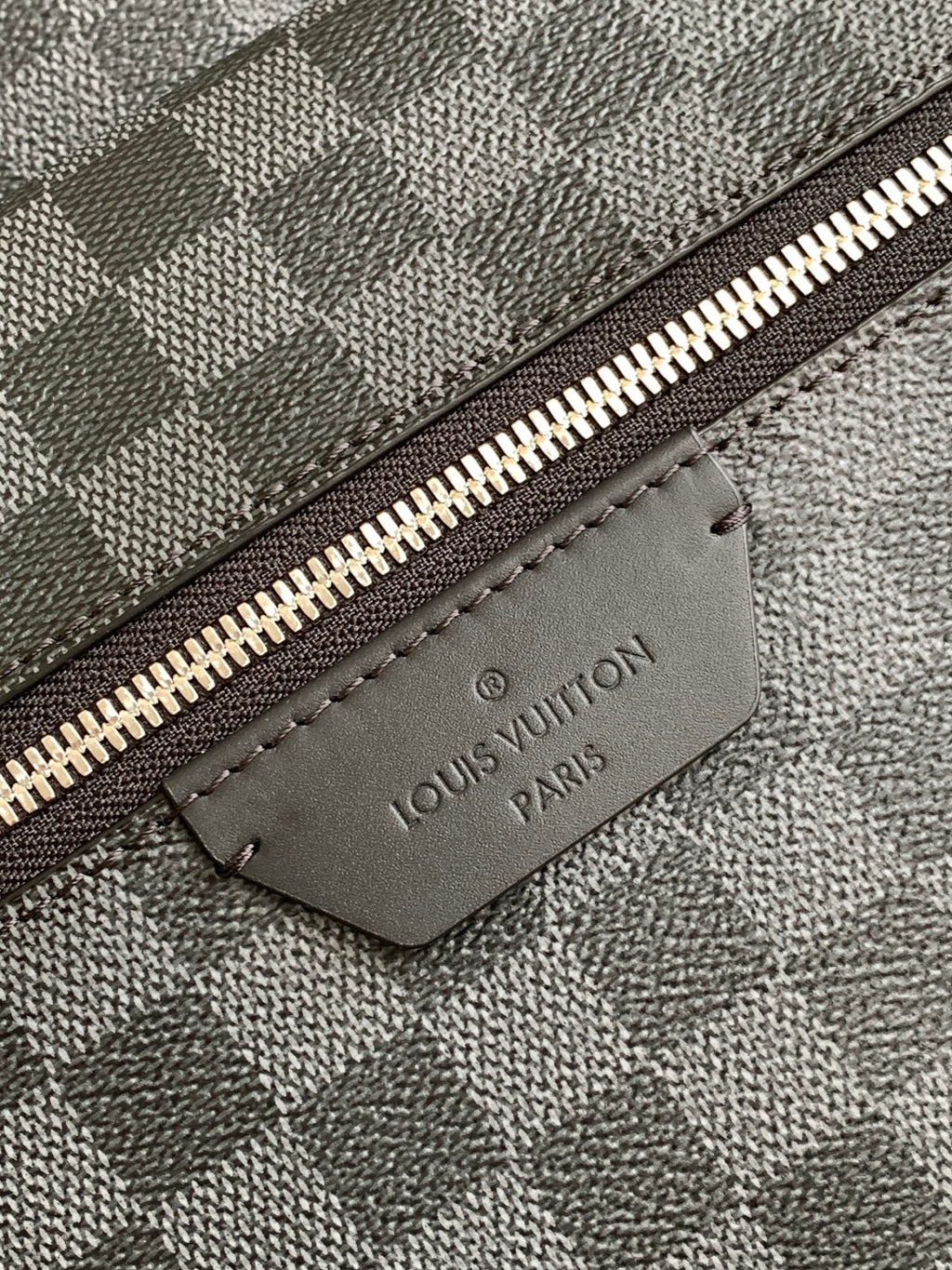 Louis Vuitton logo leather patch on checkered bag zipper track