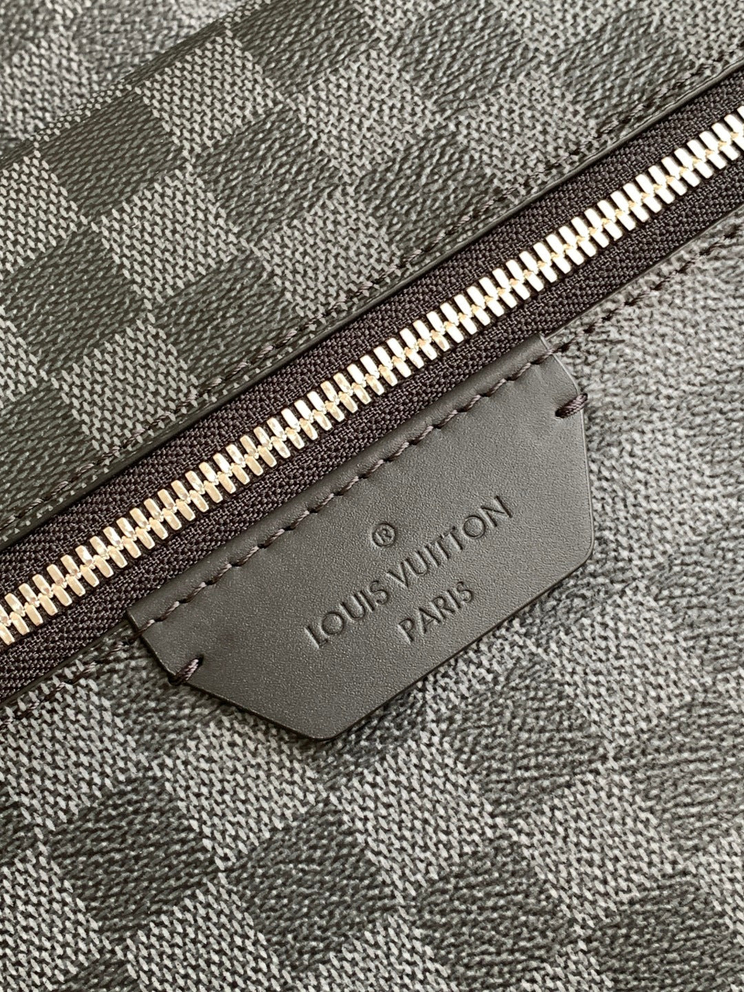 Louis Vuitton logo leather patch on checkered bag zipper track