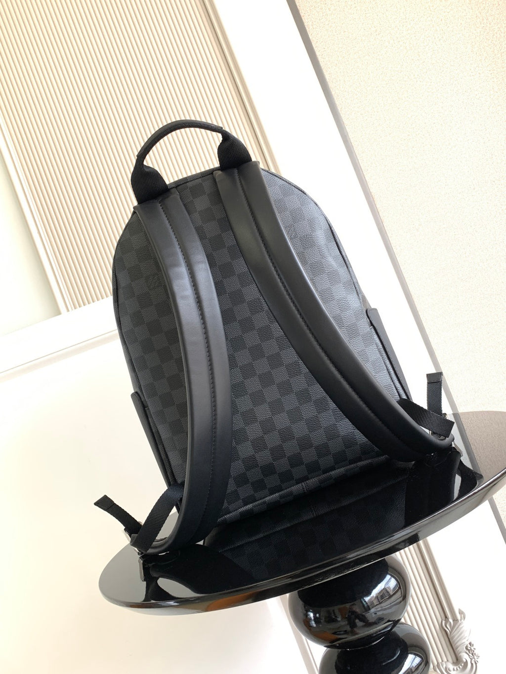 Louis Vuitton checkered backpack with adjustable straps and top handle, dark gray