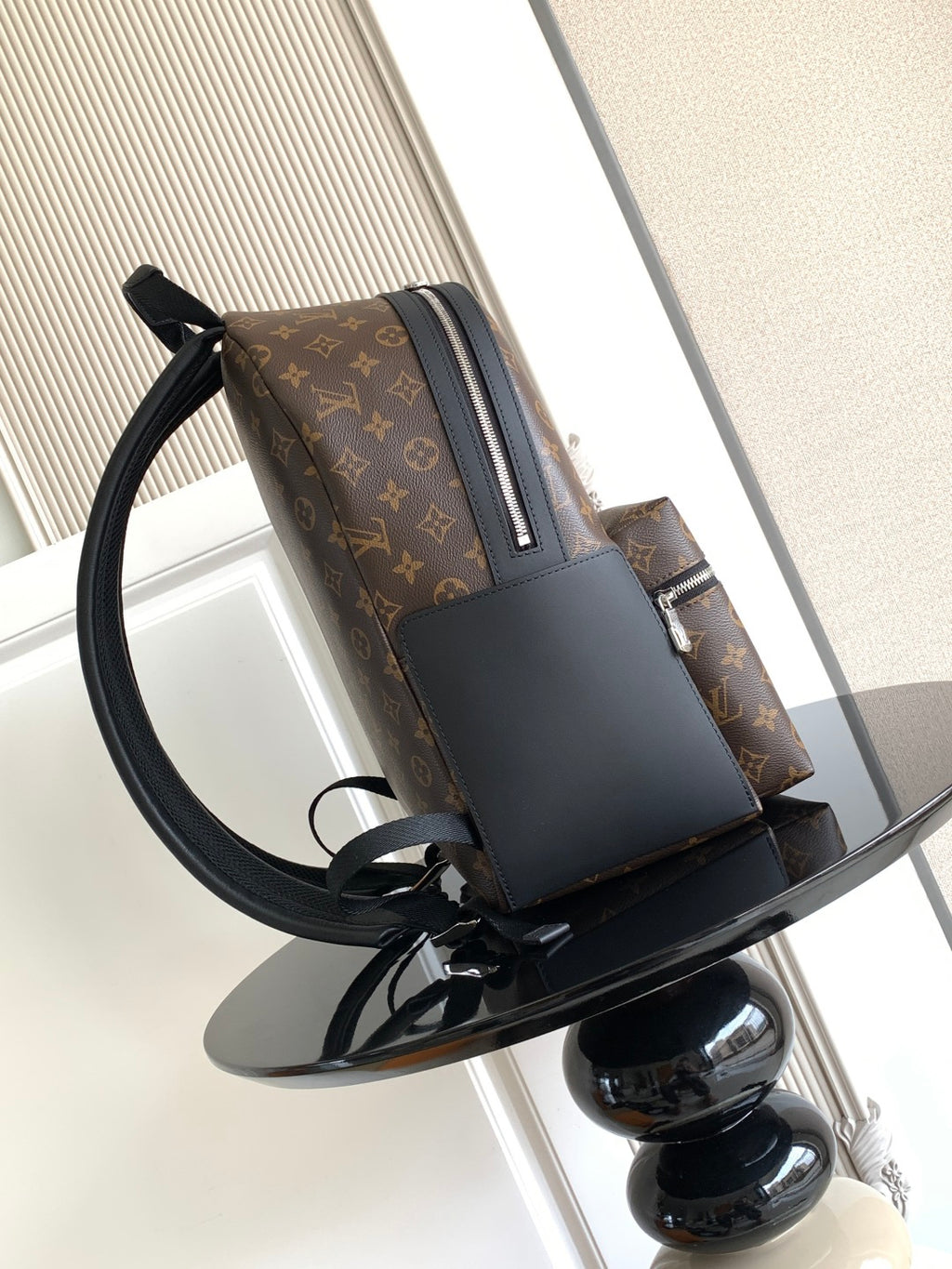 Louis Vuitton monogram backpack with side pocket and black leather panels