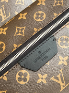 Louis Vuitton monogram backpack zipper with leather logo patch labeled Louis Vuitton Paris