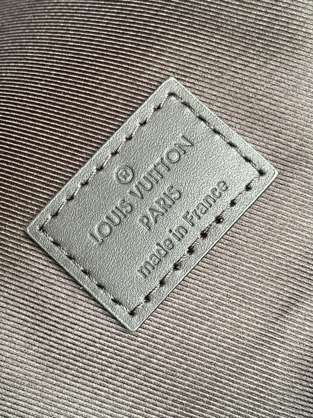 Louis Vuitton leather patch reading "Louis Vuitton" and "made in France"