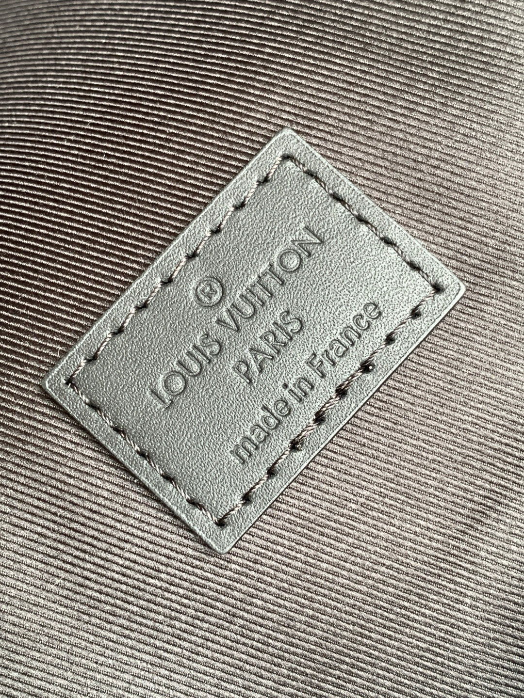 Louis Vuitton leather patch reading "Louis Vuitton" and "made in France"