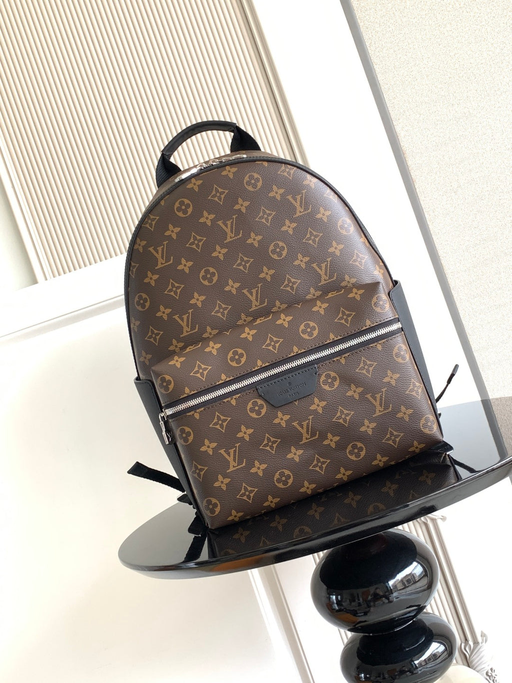 Louis Vuitton monogram backpack with front zipper and black leather trim