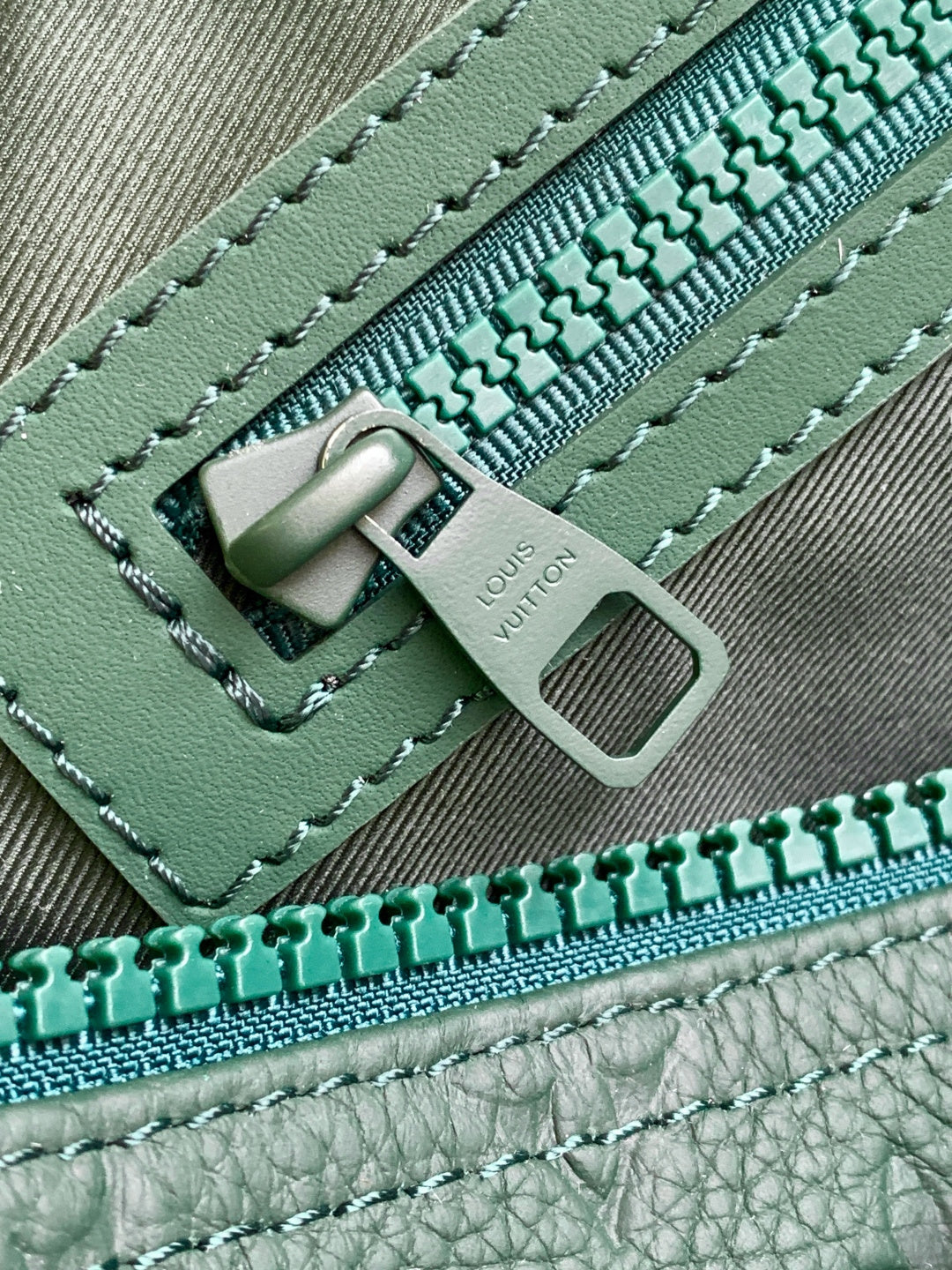 Louis Vuitton green monogram duffel bag zipper pull and stitched leather tab