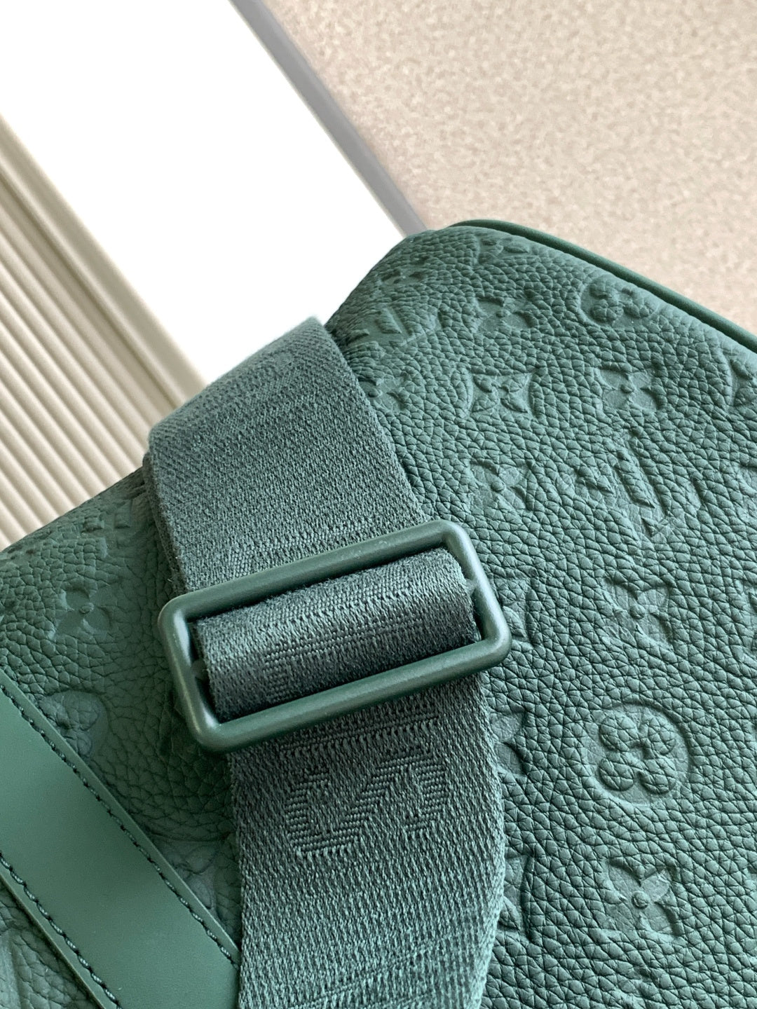Louis Vuitton green textured leather duffel bag with metal buckle detail