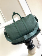 Louis Vuitton green monogram duffel bag side view with buckle strap