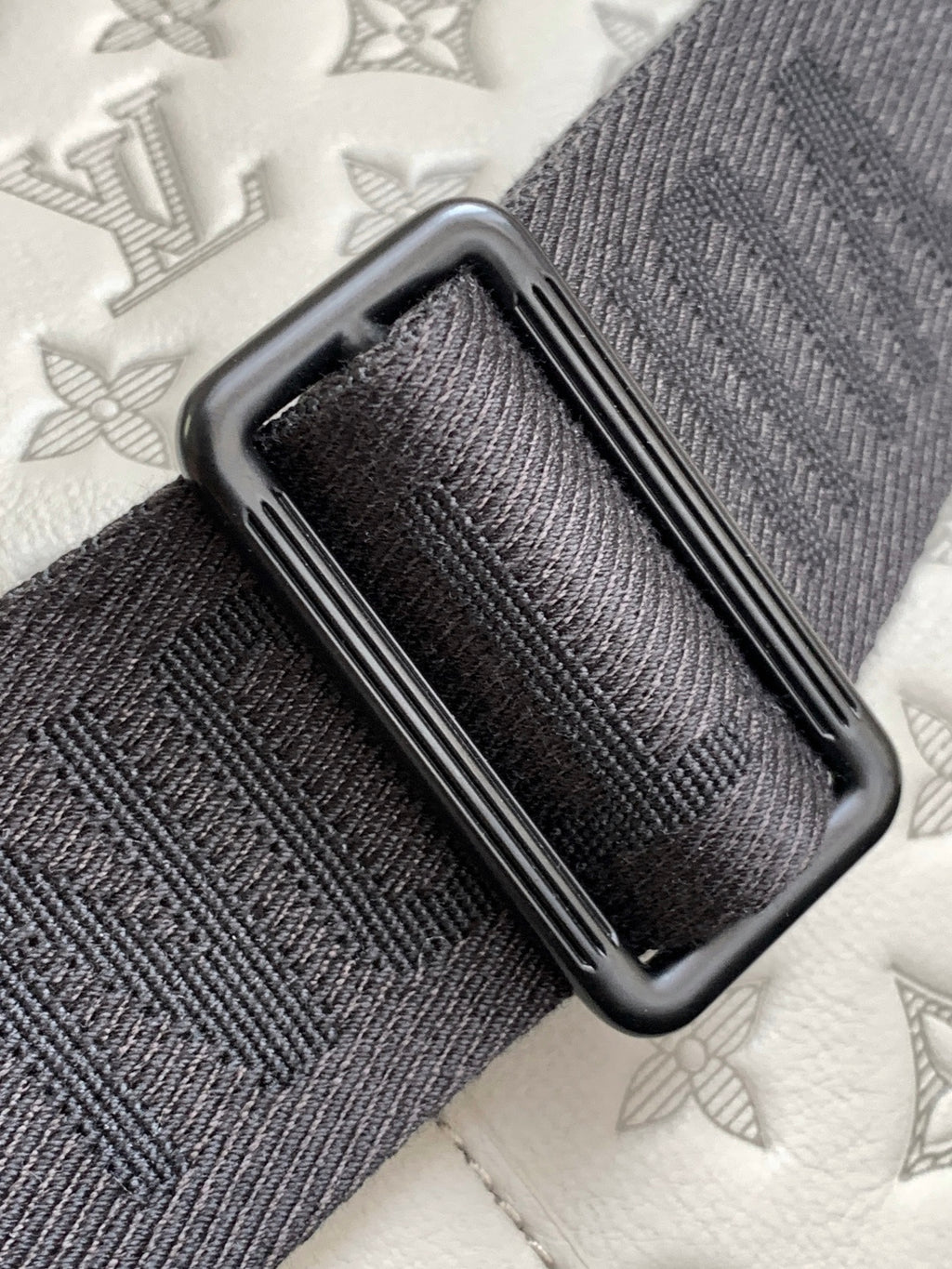 Adjustable fabric shoulder strap in dark gray with woven texture