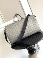 Monogram duffel bag in light gray with top handles and dark blue shoulder strap