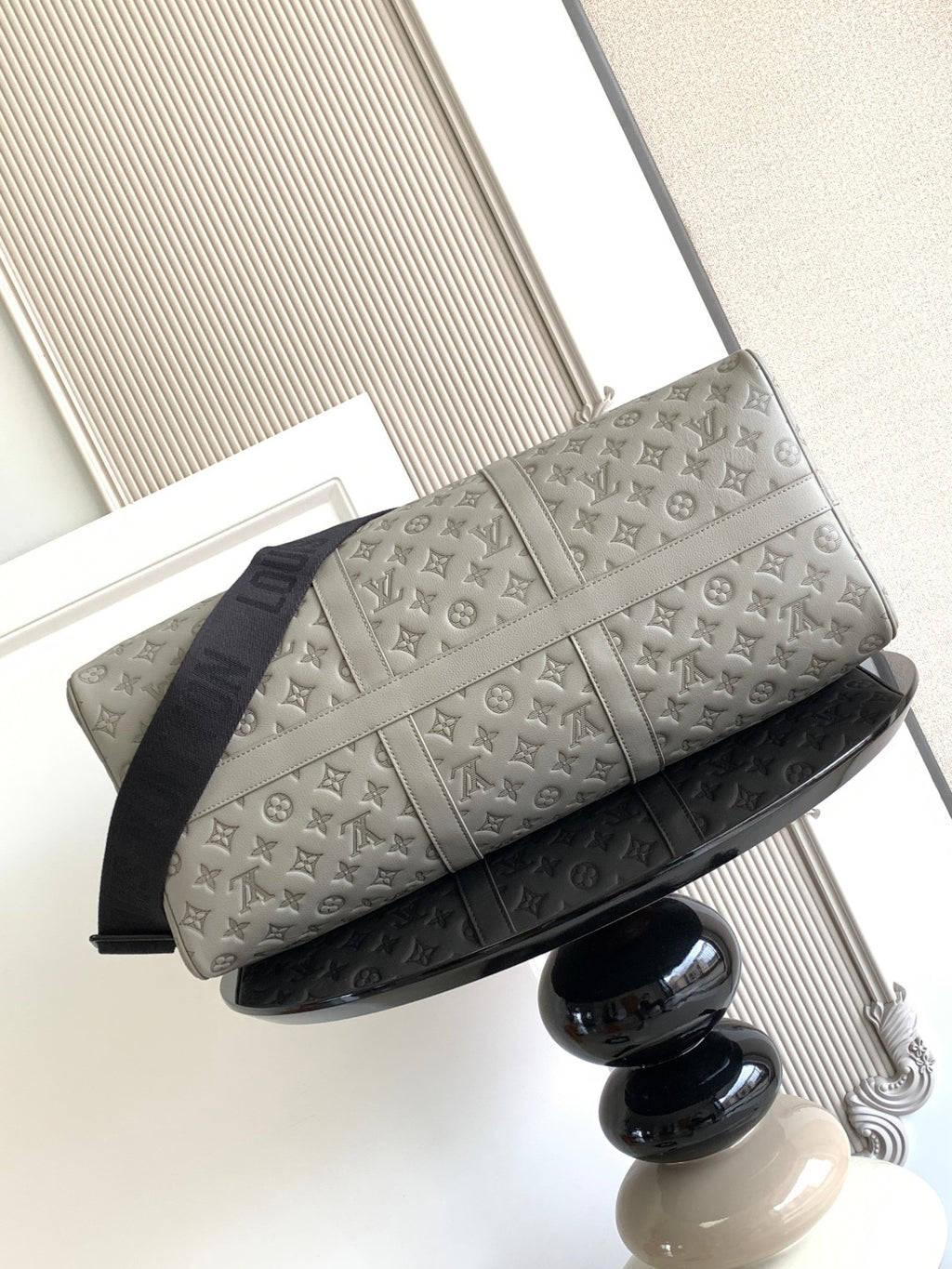 Monogram duffel bag in light gray with side stripe detail and dark navy base