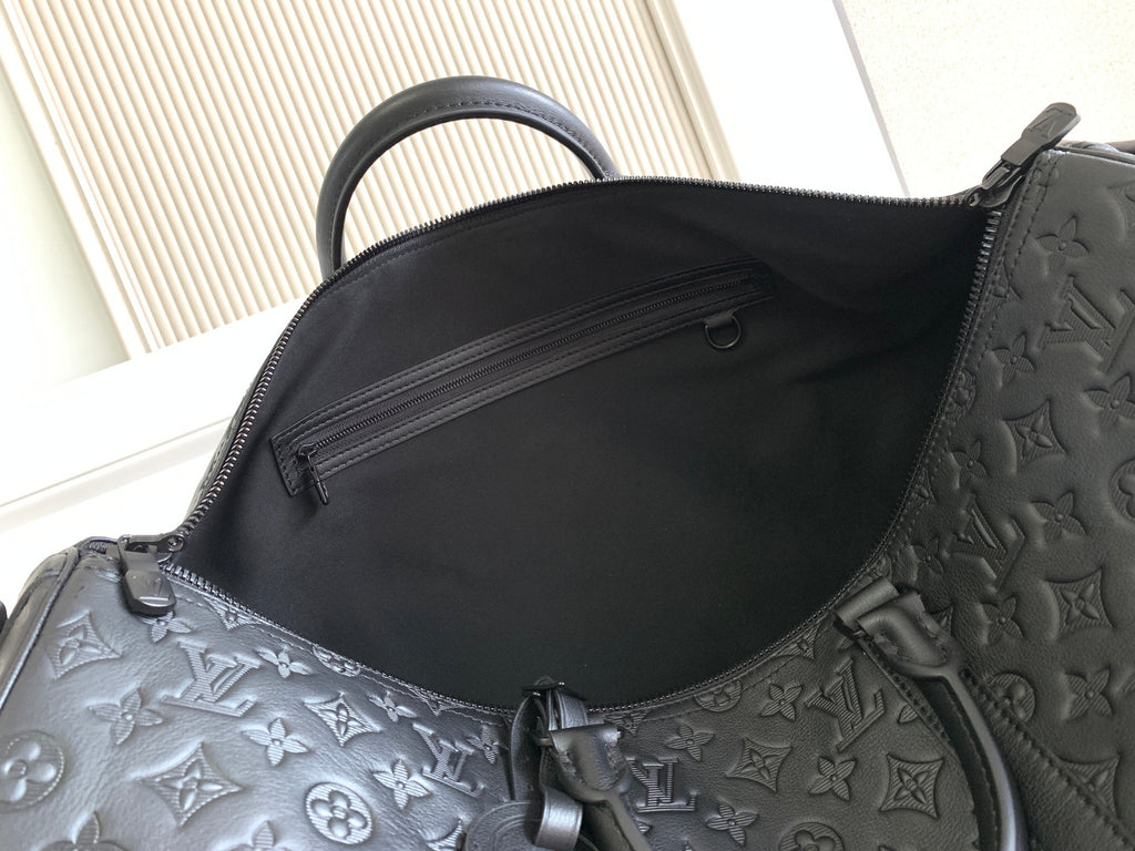 Louis Vuitton bag interior opening with dark fabric lining and embossed monogram edge