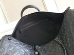 Louis Vuitton bag interior opening with dark fabric lining and embossed monogram edge