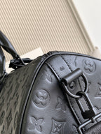 Louis Vuitton bag handle and D-ring detail on embossed monogram leather