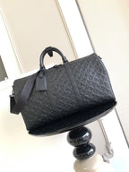 Louis Vuitton bag in dark leather with embossed monogram pattern, top handles and strap