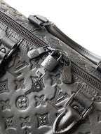 Louis Vuitton bag zipper and hardware detail with embossed monogram leather trim