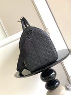 Louis Vuitton bag side view with embossed monogram design, shoulder strap and zipper