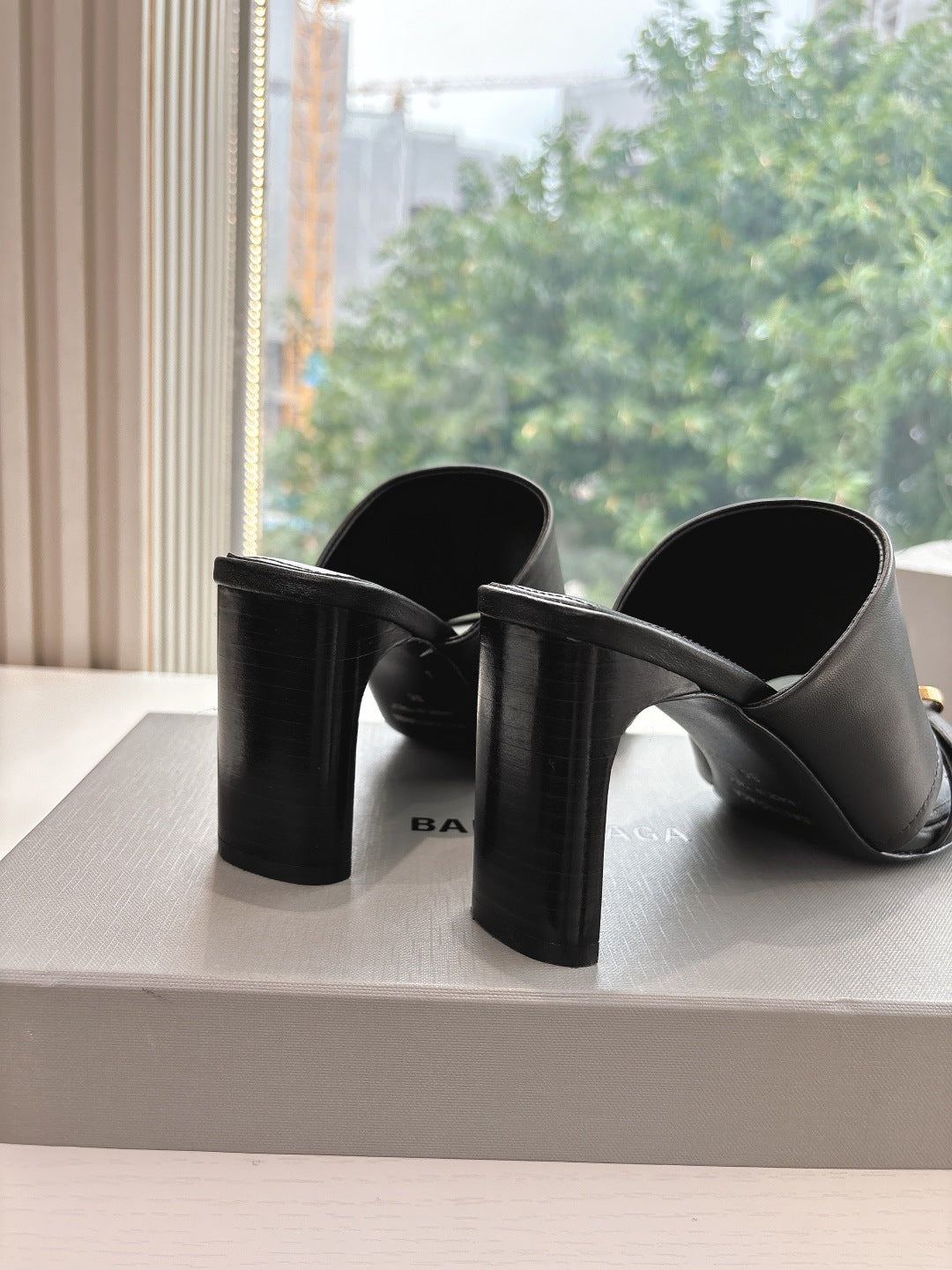 Black heeled slide sandals with chunky block heels and gold-tone buckle strap