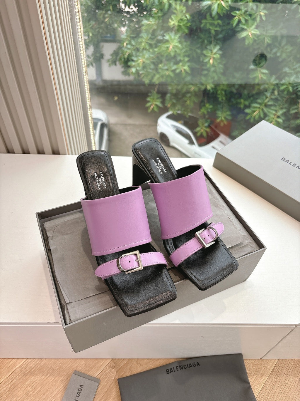 Pink and black slide sandals with square buckle straps and block heel