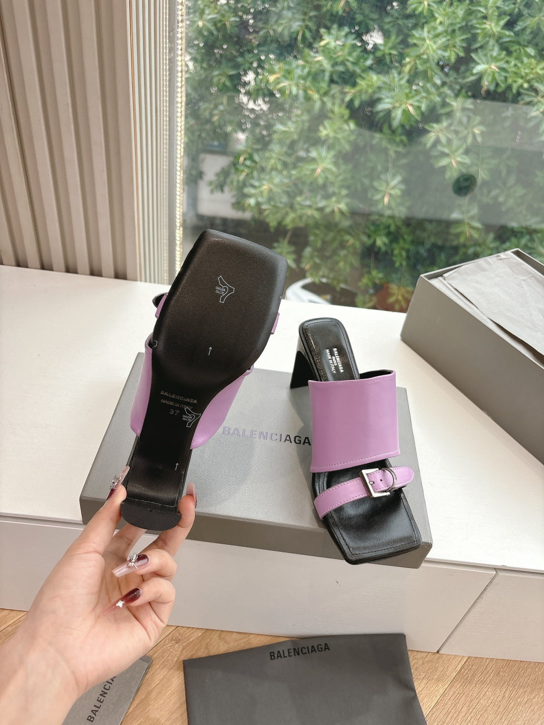 Pink and black slide sandals viewed from side, chunky block heel