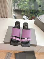 Pink and black slide sandals with double straps and square buckle closure