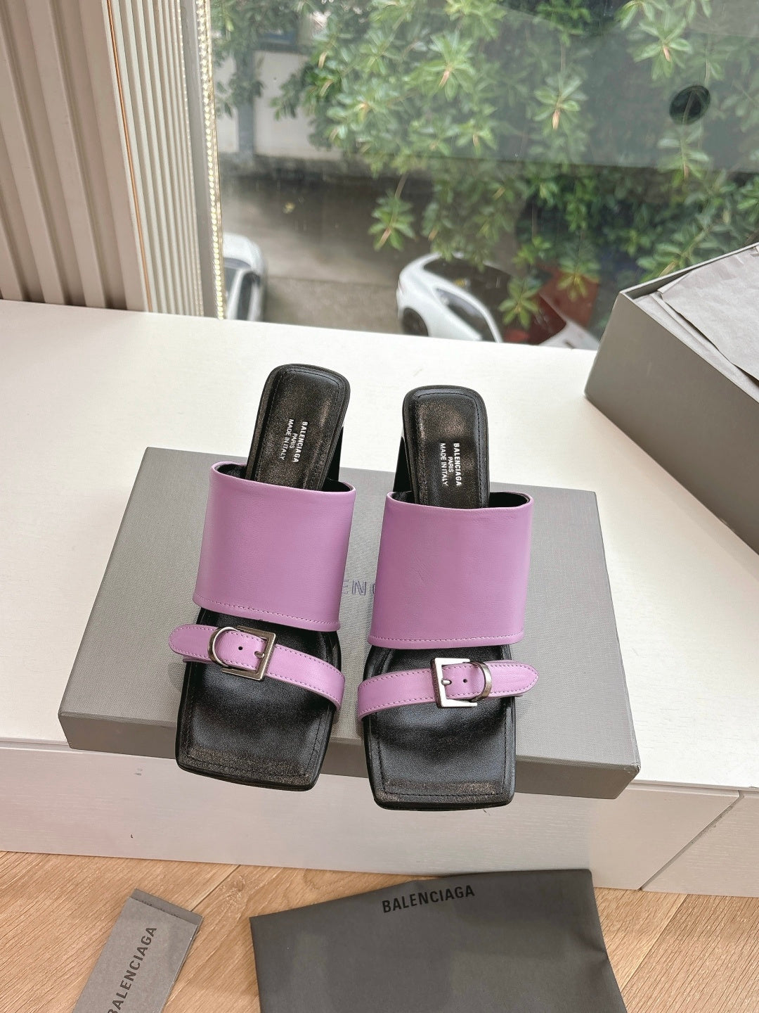Pink and black slide sandals with double straps and square buckle closure
