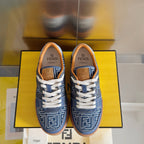 Pair of Fendi denim sneakers with FF logo on tongue, tan collar and white laces.