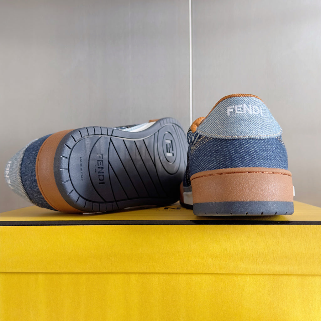 Fendi denim sneaker outsole with textured tread, tan heel, blue upper.