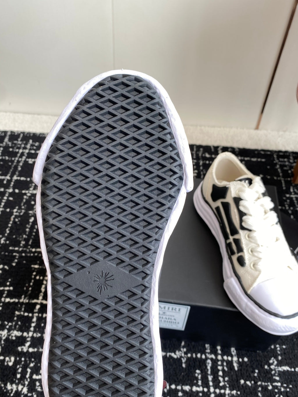White sneaker outsole tread with black grip pattern