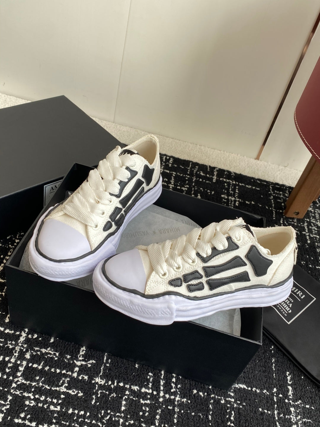 White lace-up sneakers with black side graphic and thick white platform sole