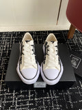 White lace-up low-top sneakers with black side pattern and cushioned white sole